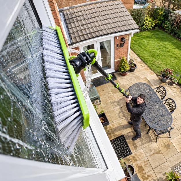 Adjustable brush head connection on a carbon fiber water fed pole during window cleaning