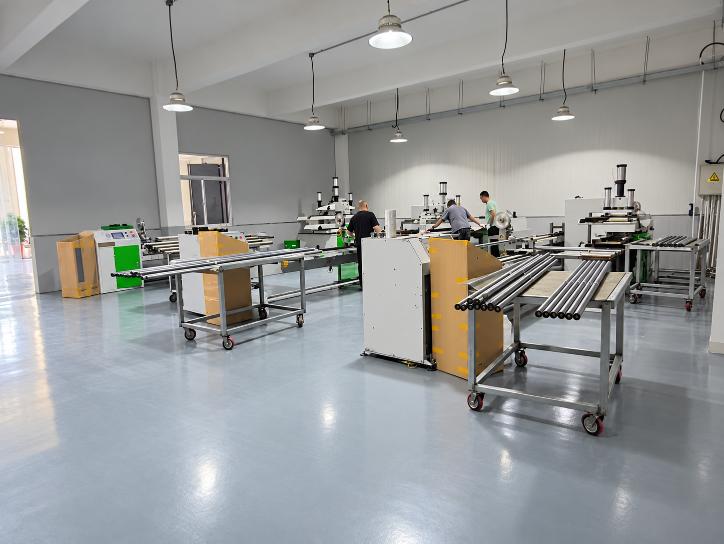Tube processing workshop with machinery and tube storage racks
